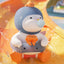 Toy penguin with a blue helmet and orange life vest in water