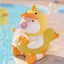 Inflatable duck toy with a smaller duck on its back by a pool