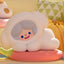 Plush toy shaped like a cloud with a face on a colorful couch