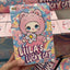 Colorful packaging of 'Liila's Lucky Cat' with cartoon character on a blurred background
