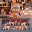 Collection of small figurines on a table with a festive background