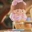 Pink piggy figurine on an ice cream cone with a blurred background