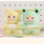 Two plush toys with animal-themed costumes in a basket against a pegboard background.