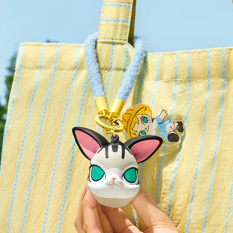 Keychain with cartoon character attached to a striped bag