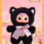 Plush toy in a black cat costume with a pink bow on a pink background