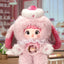 Pink plush toy with bunny ears in a room setting