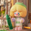 Toy figure with blonde hair and a green beret holding a green crayon in a colorful setting.