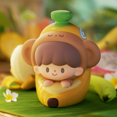 Toy figure of a monkey on a banana with a blurred nature background