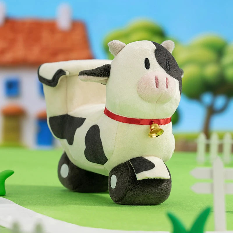 Plush cow toy with a bell on a farm-themed background