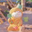 Toy figure of a character in a beach outfit with sand toys on a sandy background