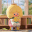 Cartoon character reading a book in a room with bookshelves
