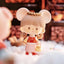 Small figurine of a character with large ears, wearing a red outfit with gold accents, on a soft white surface.