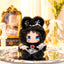 Small plush toy with black hair and blue eyes on a reflective surface, with 'Lovely Emma' branding.