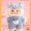 Plush toy with blue and white outfit on a pink background