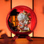 Decorative figurine inside a red glass sphere with an orange background
