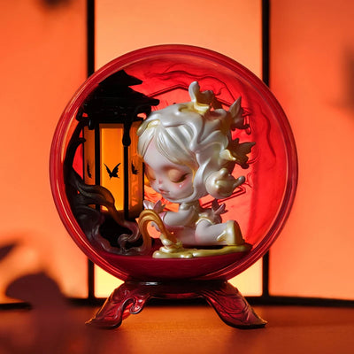 Decorative figurine inside a red glass sphere with an orange background