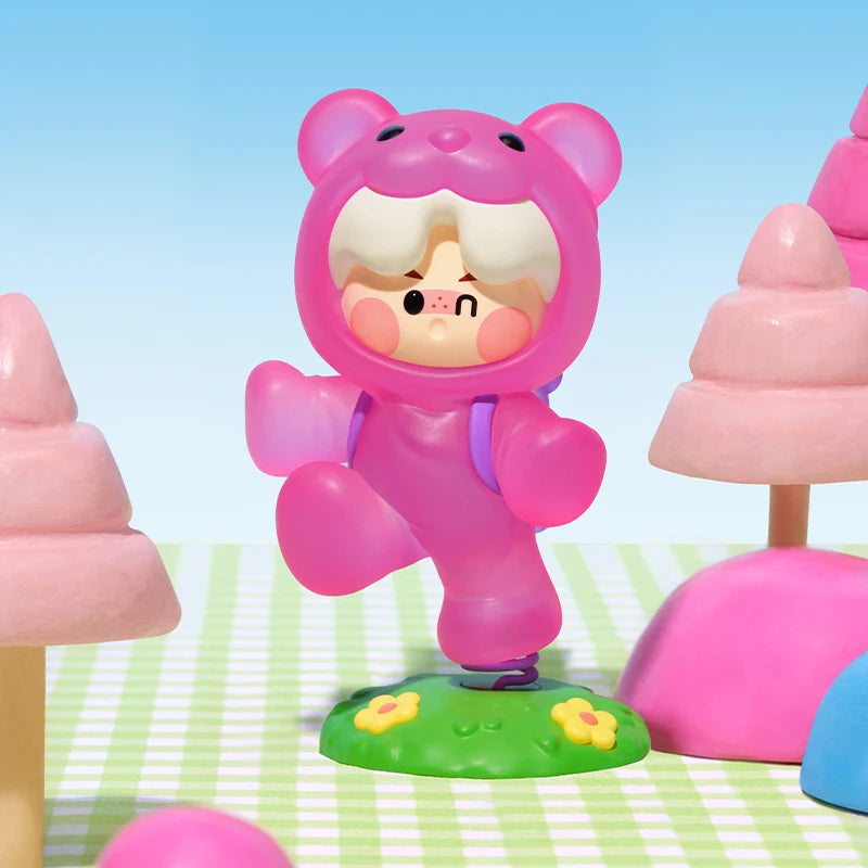 Toy figure in a pink bear costume on a colorful background