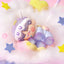 Cute plush toy with a unicorn design on a soft, cloud-like background with stars.
