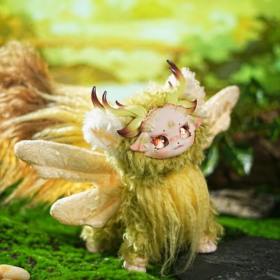 Plush toy resembling a fantasy creature with green fur, white wings, and red eyes on a natural background.