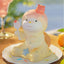 Cute ceramic character with a spoon on a plate outdoors