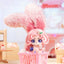 Toy figure with pink hair and a basket of small figures on a colorful background