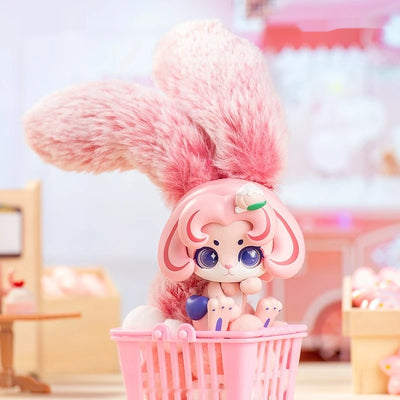 Toy figure with pink hair and a basket of small figures on a colorful background