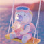 Cartoon character on a swing with a blurred beach background
