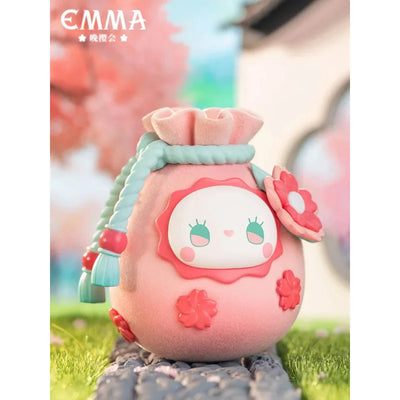 Cute plush toy with a face design on a blurred outdoor background