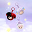 Three plush keychains with cartoon characters on a purple background with stars.