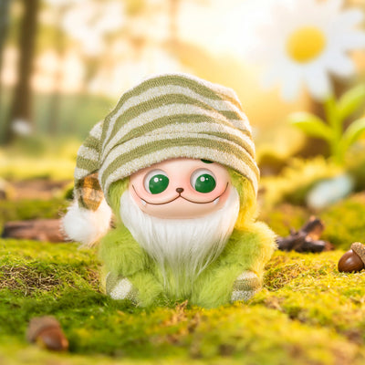 Toy gnome with a striped hat in a forest setting