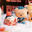 Two cartoon figurines, one penguin and one bear, standing on a snowy surface with a blurred background.