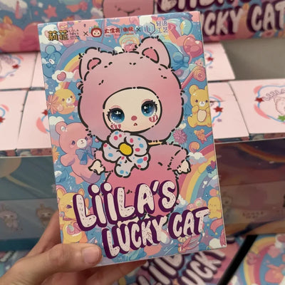 Colorful packaging of 'Liila's Lucky Cat' with cartoon character on a multicolored background.