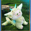 Plush toy with angelic design on a grassy background