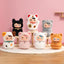 Set of small plush toys with animal-themed hats on a pink background