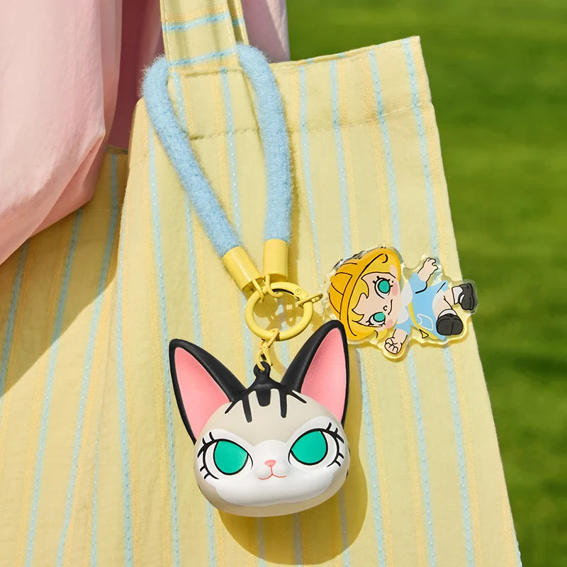 Cartoon character keychain attached to a yellow bag with a green background