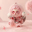 Toy figure with pink hair and outfit on a pink background