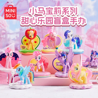 Collection of colorful toy ponies on a pink stand with MINISO branding.