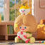Toy figure of a girl with a cat on her head in a room setting