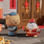 Two cartoon figurines, one bear and one penguin, holding traditional Chinese New Year items on a festive background.