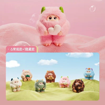 Pink plush toy with green accents on a pink background, with additional toys in the background.