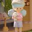 Toy figure of a child holding a lamb with a soft background