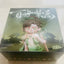 Box with a figurine and text on a light background