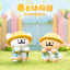 Two cartoon animal figurines in yellow hats on grass with 'KinderGarten' text in the background