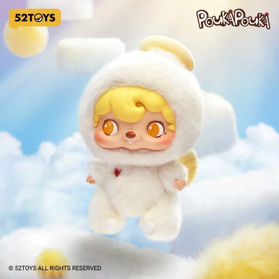Plush toy of a character from Pouká Pouké with a white outfit and yellow hair against a cloudy sky background.