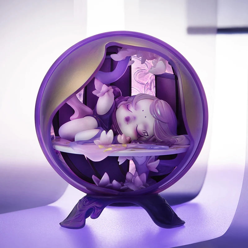 Decorative figurine with a purple base and a small character inside on a white background