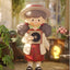 Decorative figurine of a girl holding a record in a home setting with plants and furniture.