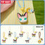 Set of cat-themed keychains with colorful straps on a yellow fabric background, featuring the Pop Mart brand.