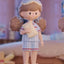 Toy figure of a girl in a uniform with a blurred background